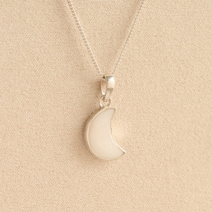 Silver Moon memorial Necklace with white resin, filled with ashes or fur, displayed on a soft beige background – suitable for pet or human memorials.