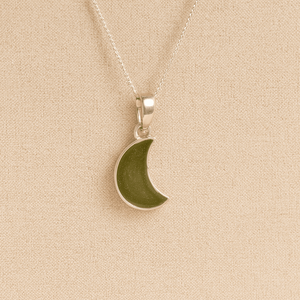 Silver Moon memorial Necklace with sage resin, filled with ashes or fur, displayed on a soft beige background – suitable for pet or human memorials.