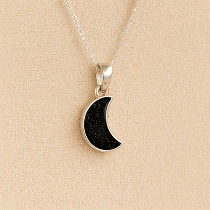 Silver Moon memorial Necklace with black resin, filled with ashes or fur, displayed on a soft beige background – suitable for pet or human memorials.