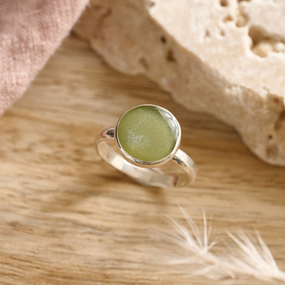Sage resin cremation ring in sterling silver on wooden table – handmade keepsake jewellery