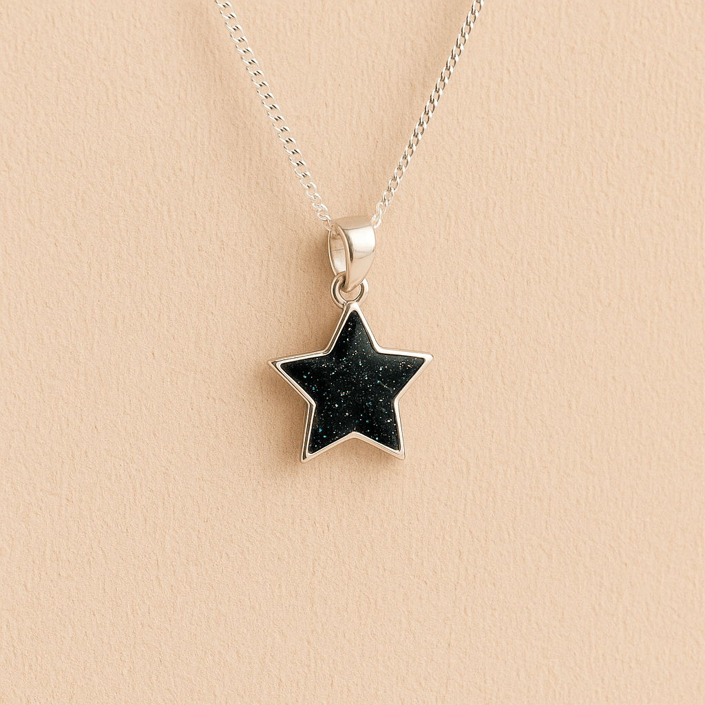 Silver star ashes pendant with Black resin on a beige background