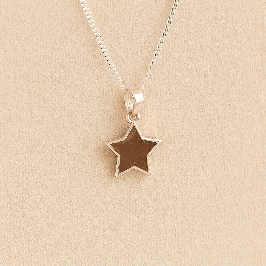 Silver star memorial necklace with mocha resin on a beige background