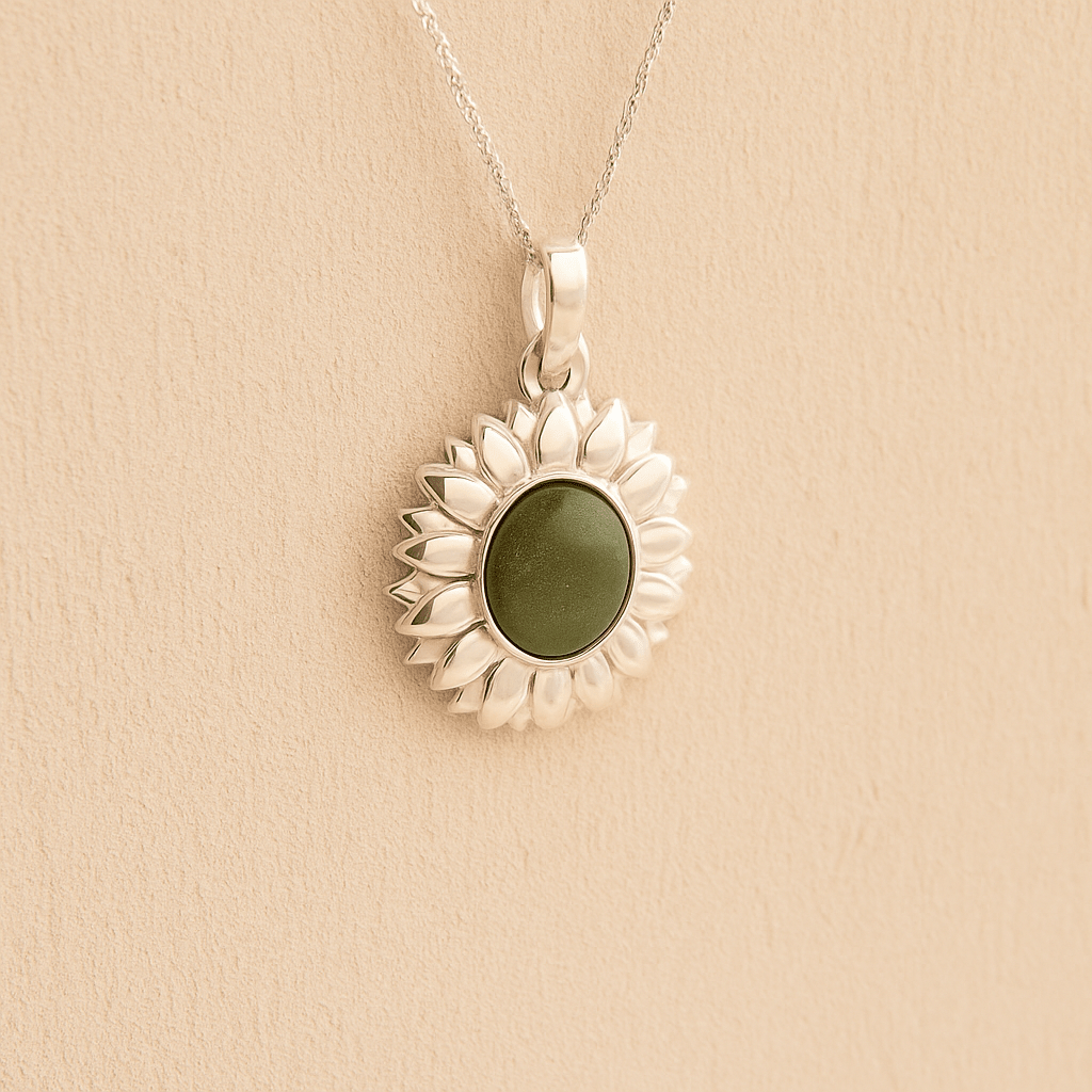 Silver Sunflower Memorial Necklace with a sage resin infill containing ashes or fur set on a beige textured background