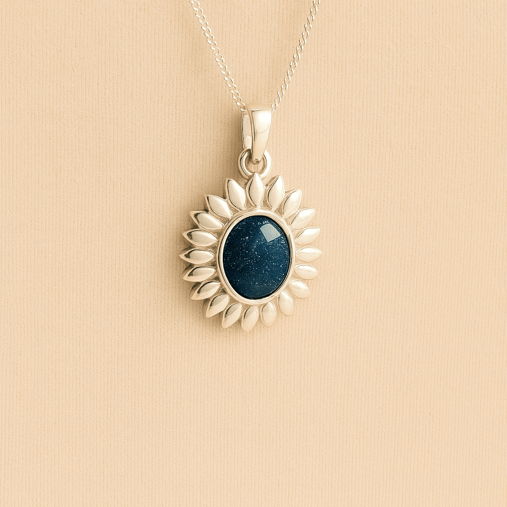 Silver Sunflower Memorial Necklace with a navy resin infill containing ashes or fur set on a beige textured background