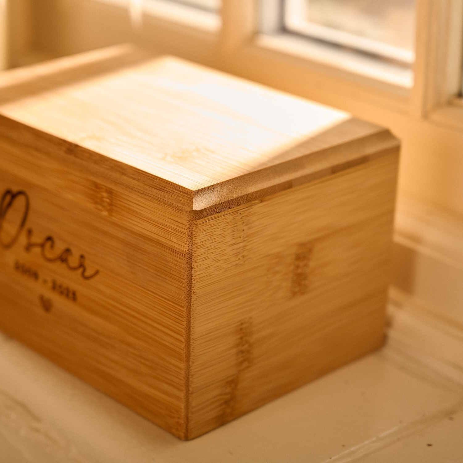Close-up of custom engraved bamboo wood pet cremation urn – handcrafted memorial